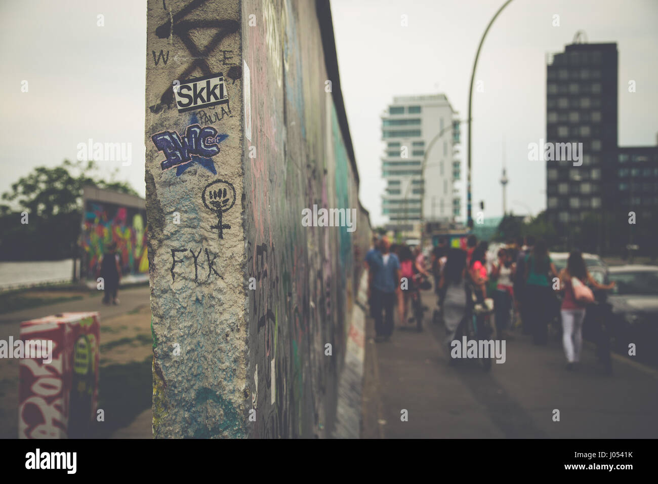 Vista panoramica del famoso muro di Berlino decorate con colorati graffiti street art alla storica East Side Gallery su un moody giorno nuvoloso con retro vintag Foto Stock