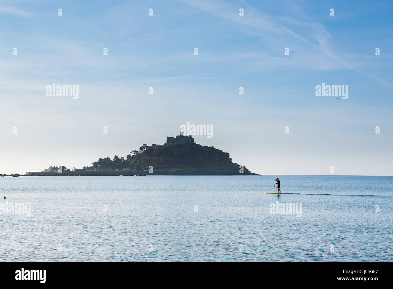 Marazion, Cornwall, Regno Unito. 11 aprile 2017. Regno Unito Meteo. Mare calmo per prima cosa al mattino a Marazion, con paddle boarder e cigni sul mare. Credito: Simon Maycock/Alamy Live News Foto Stock