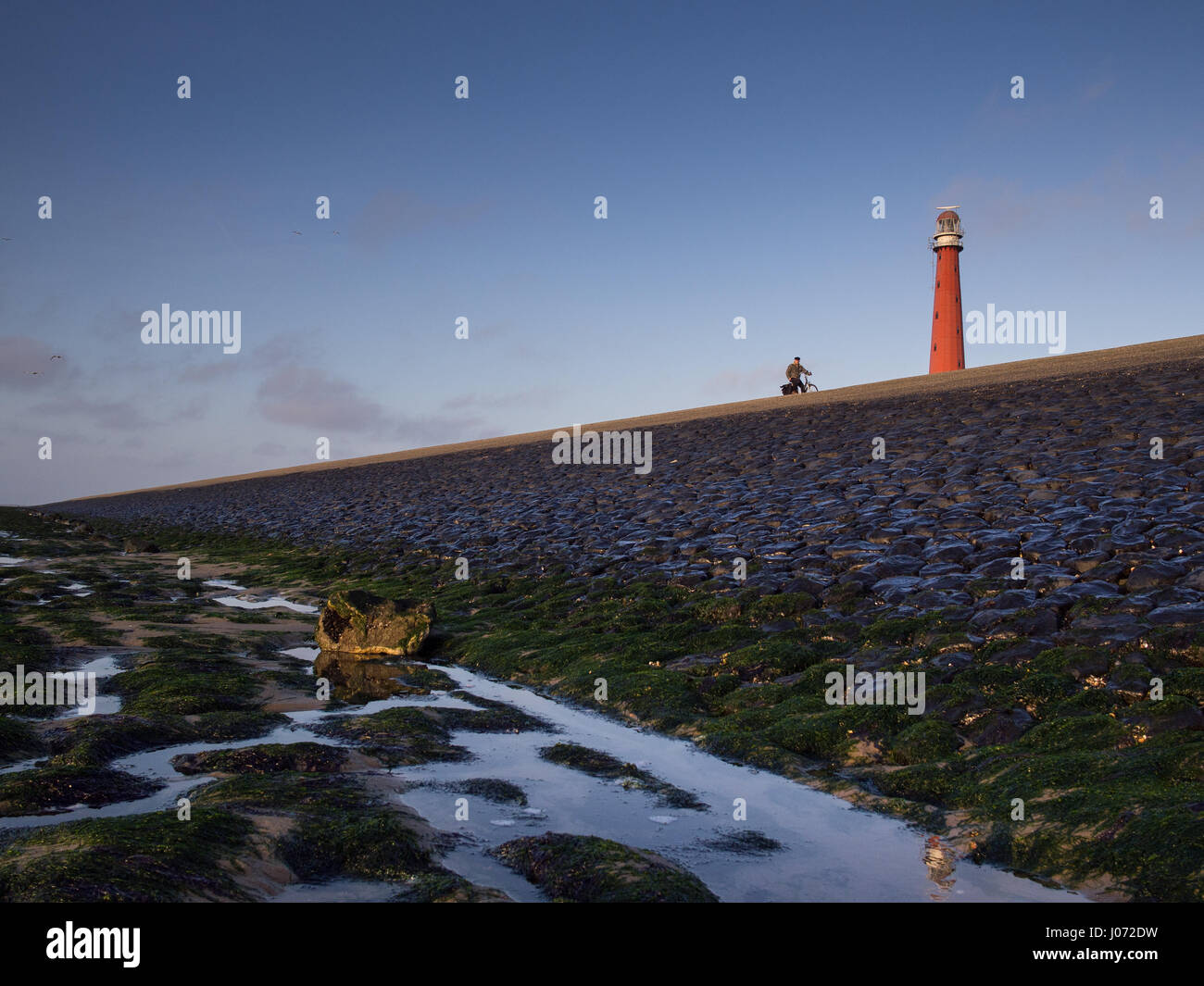 Faro e dyke con bicicletta atto Foto Stock