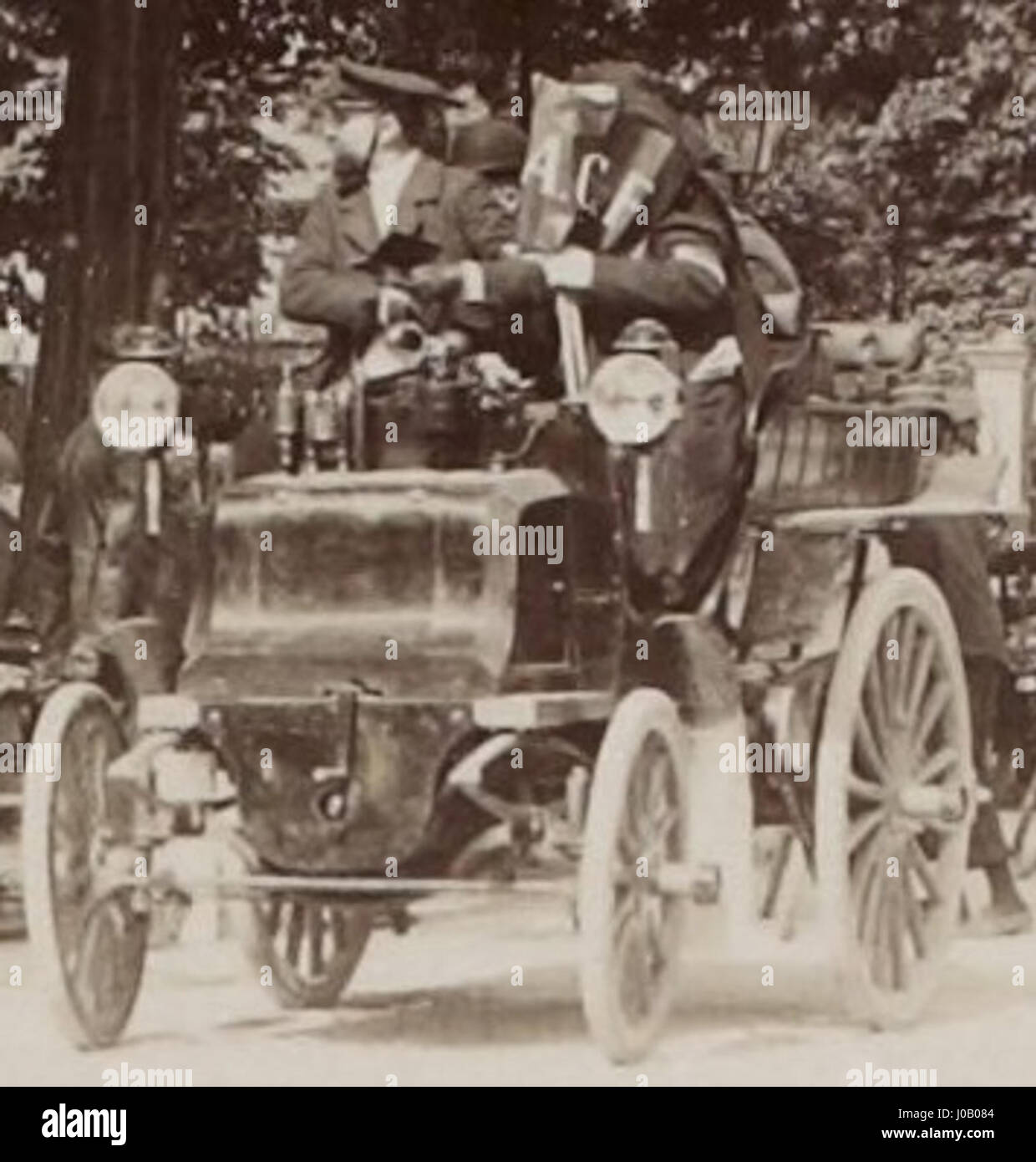 Questa immagine cattura i partecipanti ufficiali all'inizio della gara automobilistica Parigi-Amsterdam-Parigi 1898, con un portabandiera dell'Automobile Club de France (A.C.F.). L'evento fu una gara importante nella storia degli sport motoristici, mostrando la crescente popolarità delle automobili. Foto Stock