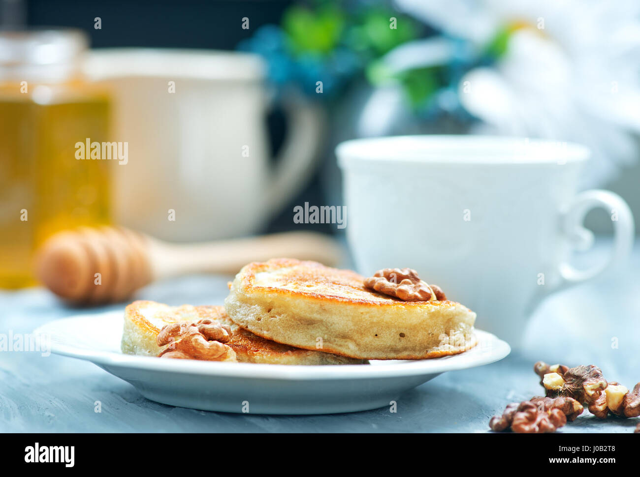 Frittelle con noci e miele su un tavolo Foto Stock