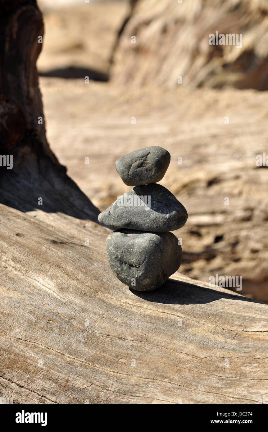 Bilanciamento - piramidi di pietra sullo sfondo di legno Foto Stock