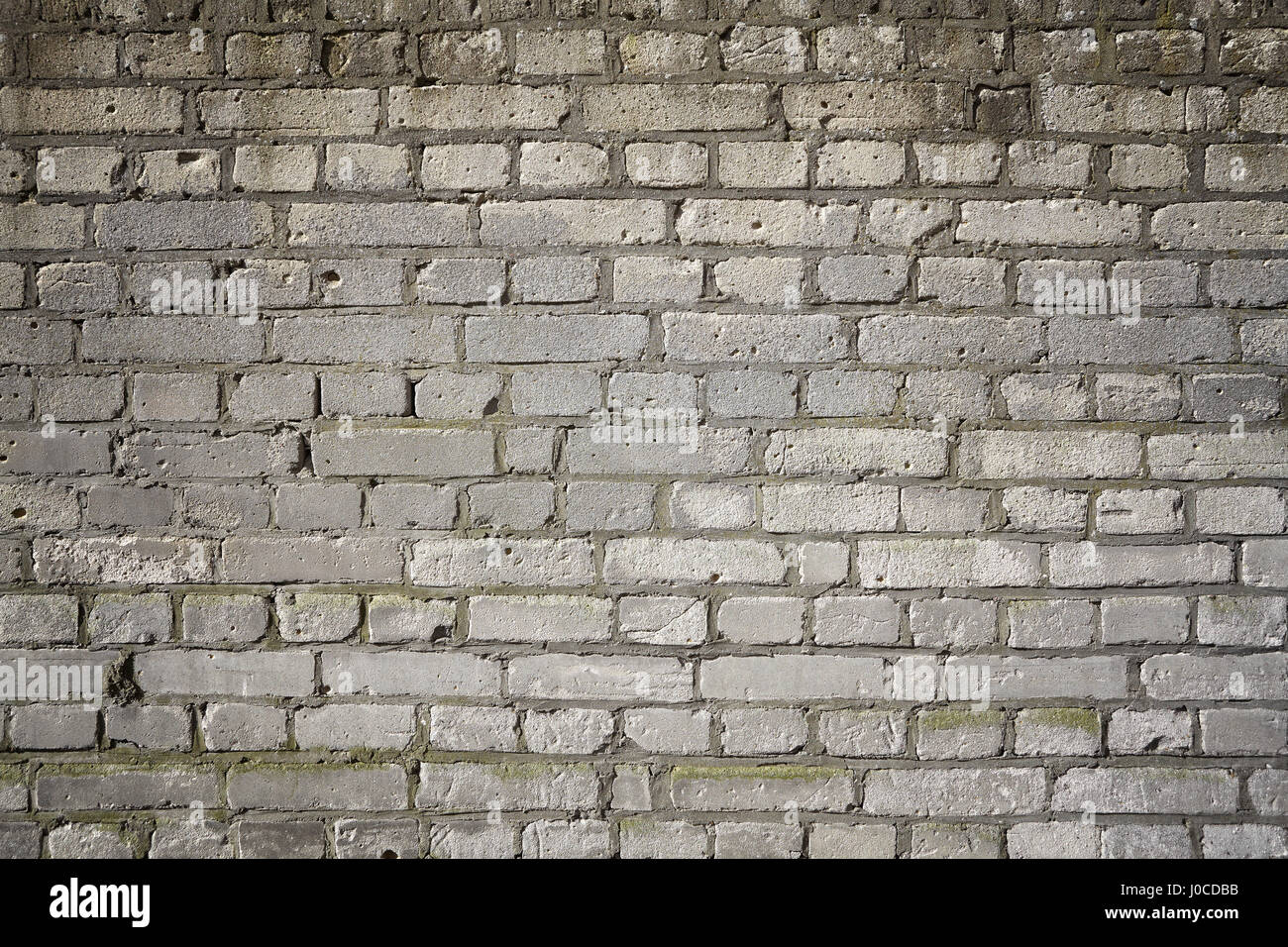 Immagine di un vecchio grigio weathered muro di mattoni, sfondo o texture. Foto Stock