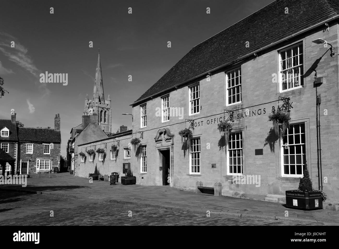 La Buttercross in legno, Post office edificio e tutti i santi della chiesa parrocchiale, città mercato di Oakham, Rutland County, Inghilterra, Foto Stock