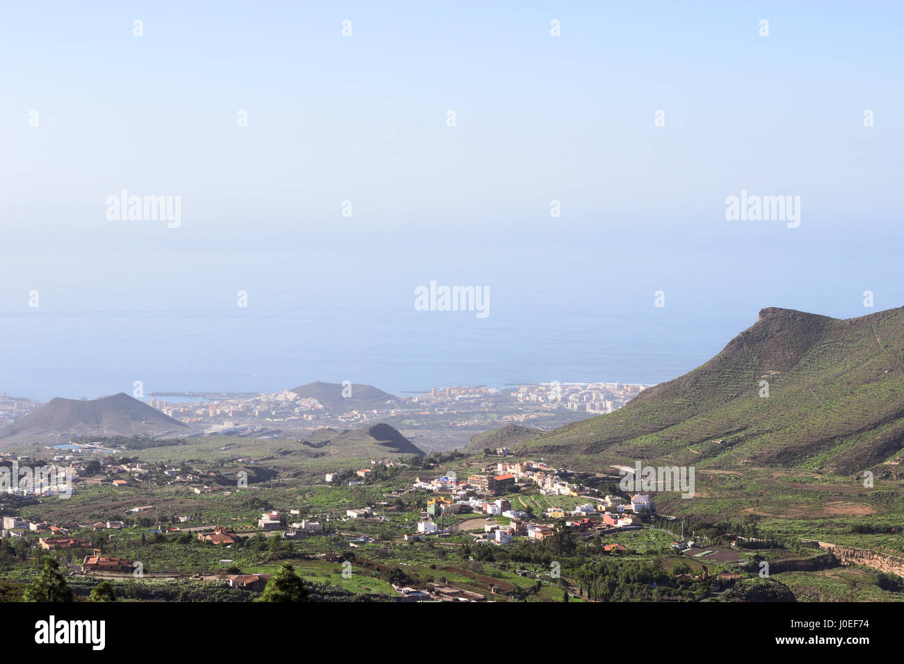 La parte meridionale dell'isola di Tenerife con piccoli villaggi ai pendii della montagna e Las Americas città sulla costa atlantica, vista aerea dal mirador. Può Foto Stock