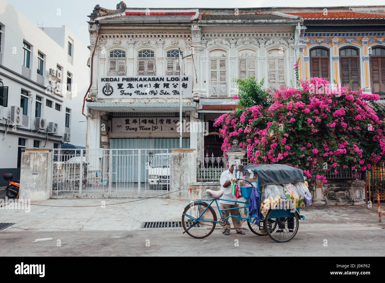 George Town, Malesia - 22 Marzo 2016: il fornitore vende spuntini dal triciclo nel Patrimonio Mondiale di UNESCO zona di buffer di George Town, Penang, Malaysia di Marc Foto Stock