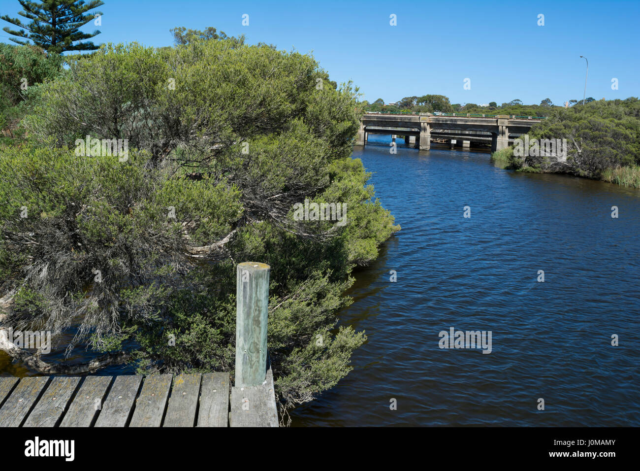 Il treno e la strada dei ponti che attraversano il fiume Hindmarsh vicino alla bocca a Victor Harbor, Fleurieu Peninsula, Sud Australia, da un piccolo molo. Foto Stock