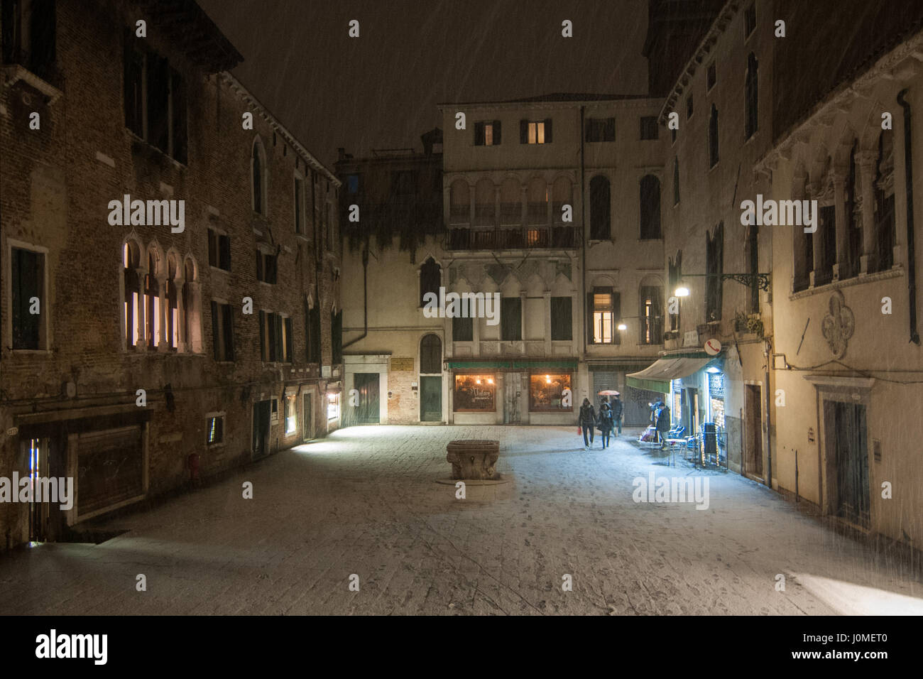 La gente a piedi in Santa Maria Mater Domini piazza durante una neve pesante a Venezia. Foto Stock