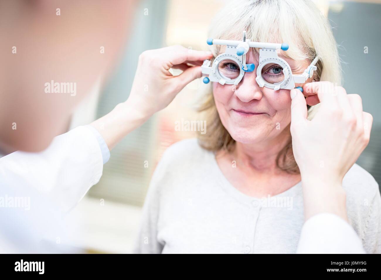 Senior donna con esame visivo da all'ottico optometrista. Foto Stock