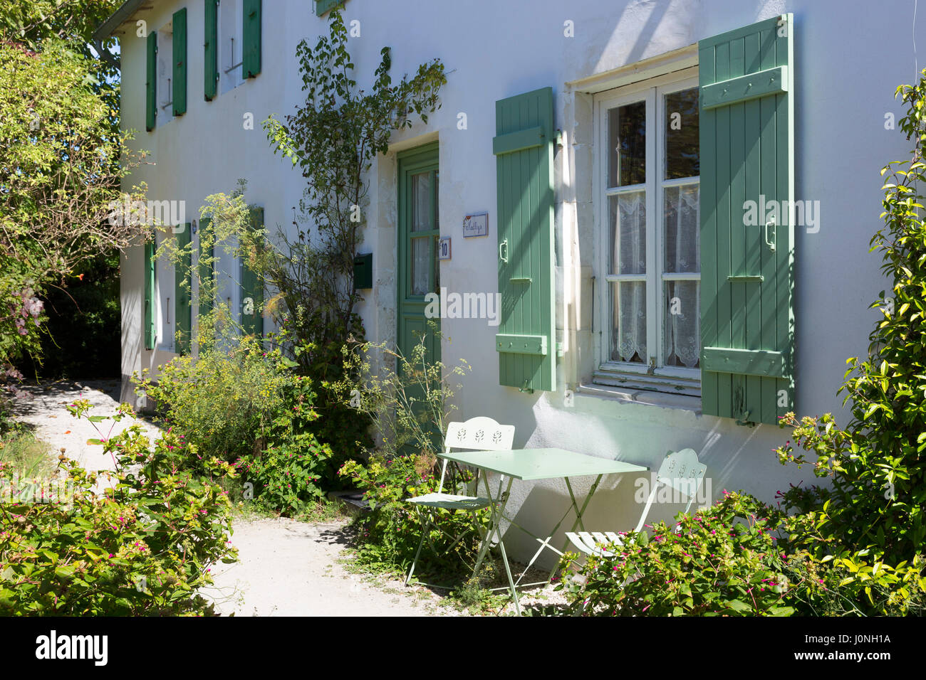Tipica casa caratteristico con persiane di architettura tradizionale, dipinto in colore verde chiaro a Les Portes en Re, Ile de Re, Francia Foto Stock