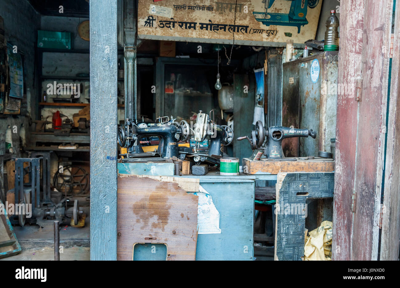 Tradizionale e vecchio canto messo in moto le macchine da cucire in un negozio di Pragpur, un villaggio del patrimonio culturale nel quartiere Kagra, Himachal Pradesh, India Foto Stock