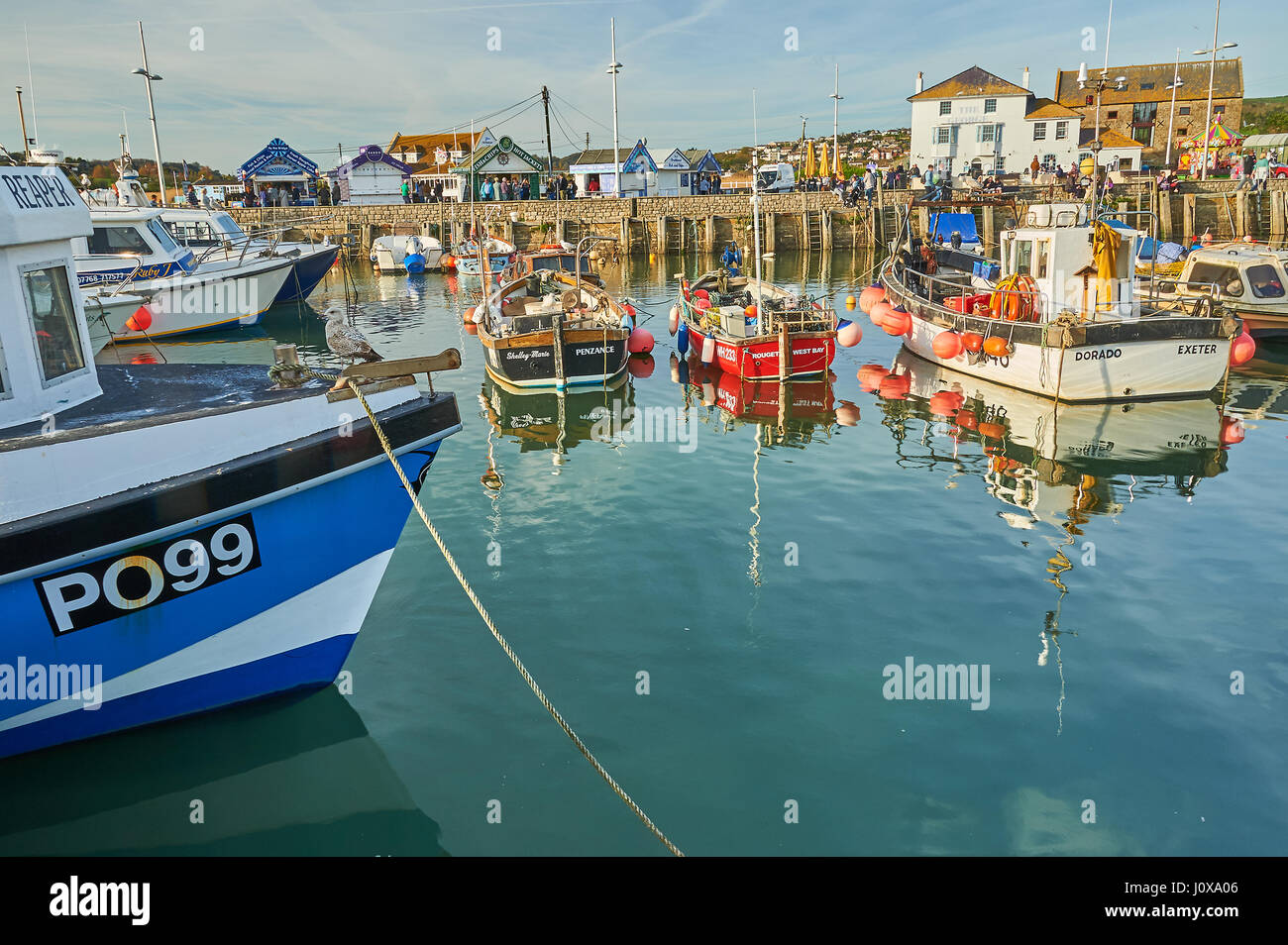 Alta Marea, barche da pesca e le navi per la pesca a strascico nella piccola località balneare di West Bay su Dorset la Jurassic Coast. Foto Stock
