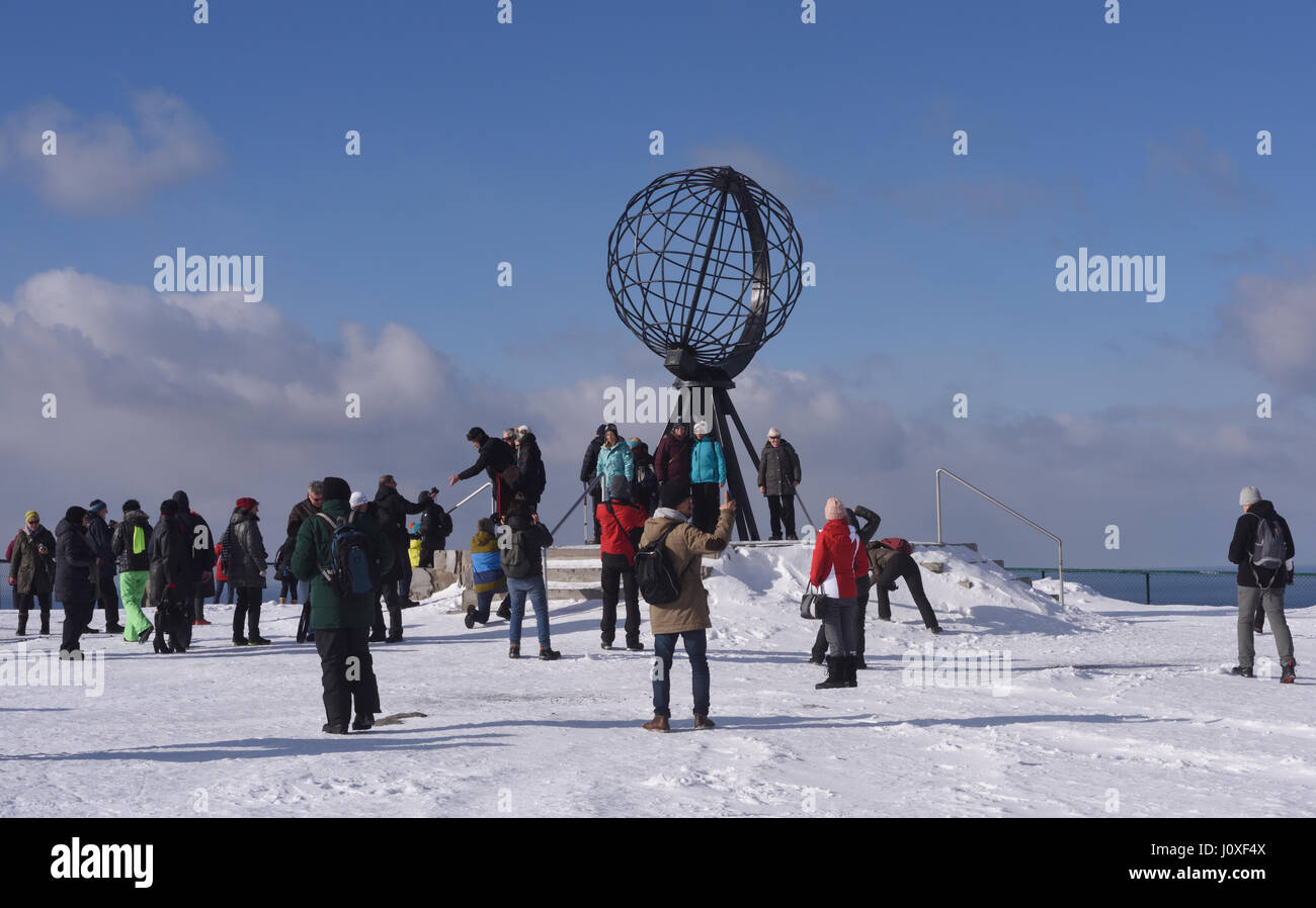 Turisti si riuniscono attorno al globo monumento su Capo Nord, Nordkapp. Nordkapp, Finmark, Norvegia. Foto Stock