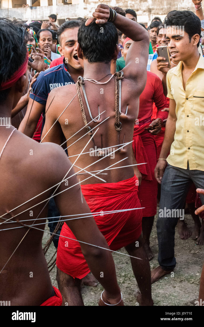 Giovane uomo con ganci di carne nel suo ritorno al Gajan e charak festival in Krishnadepur, Bengala occidentale Foto Stock