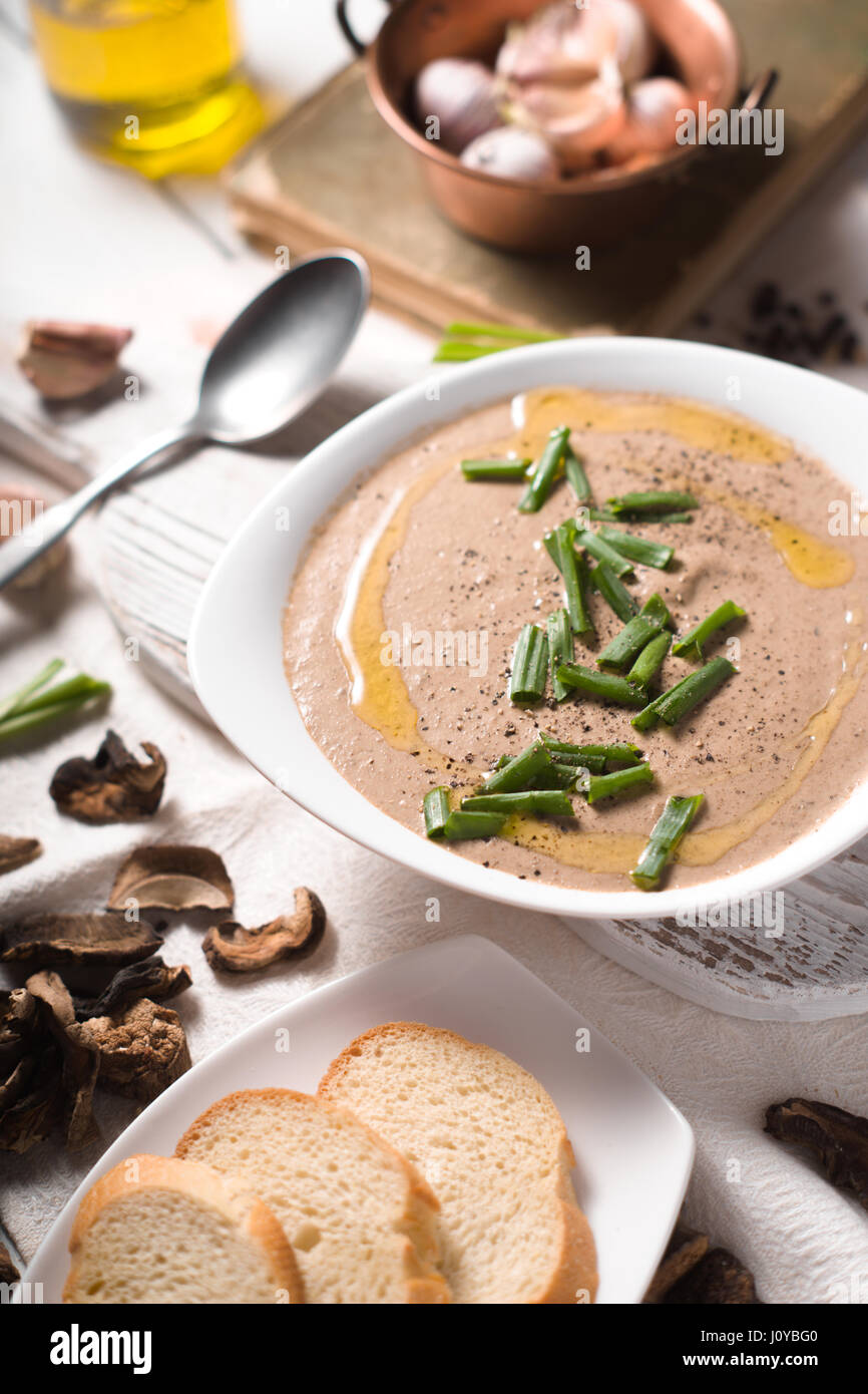Mushroom cream soup sul legno bianco verticale di sfondo Foto Stock