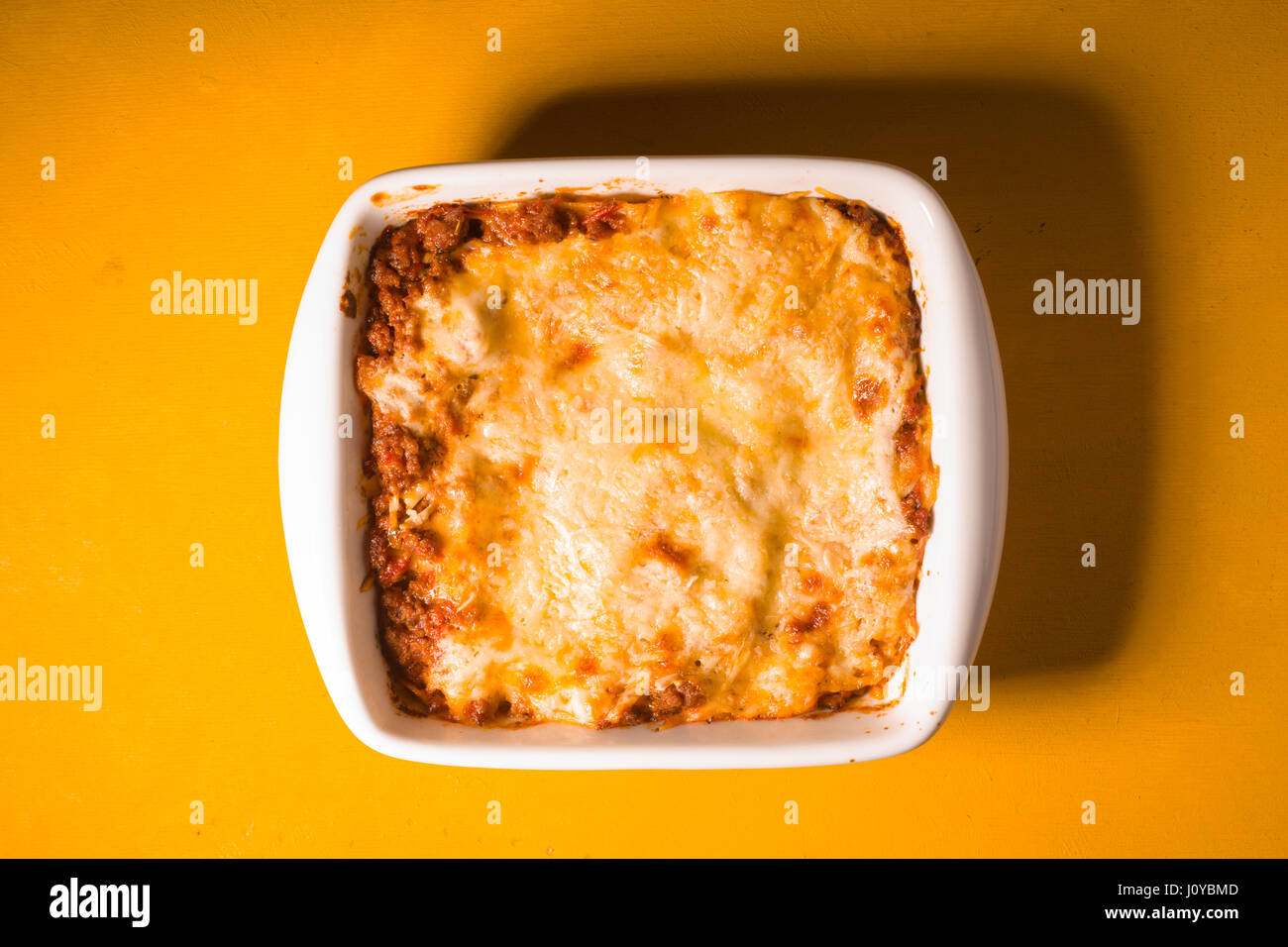 In casa lasagna di carne su legno Tabella di colore giallo Foto Stock