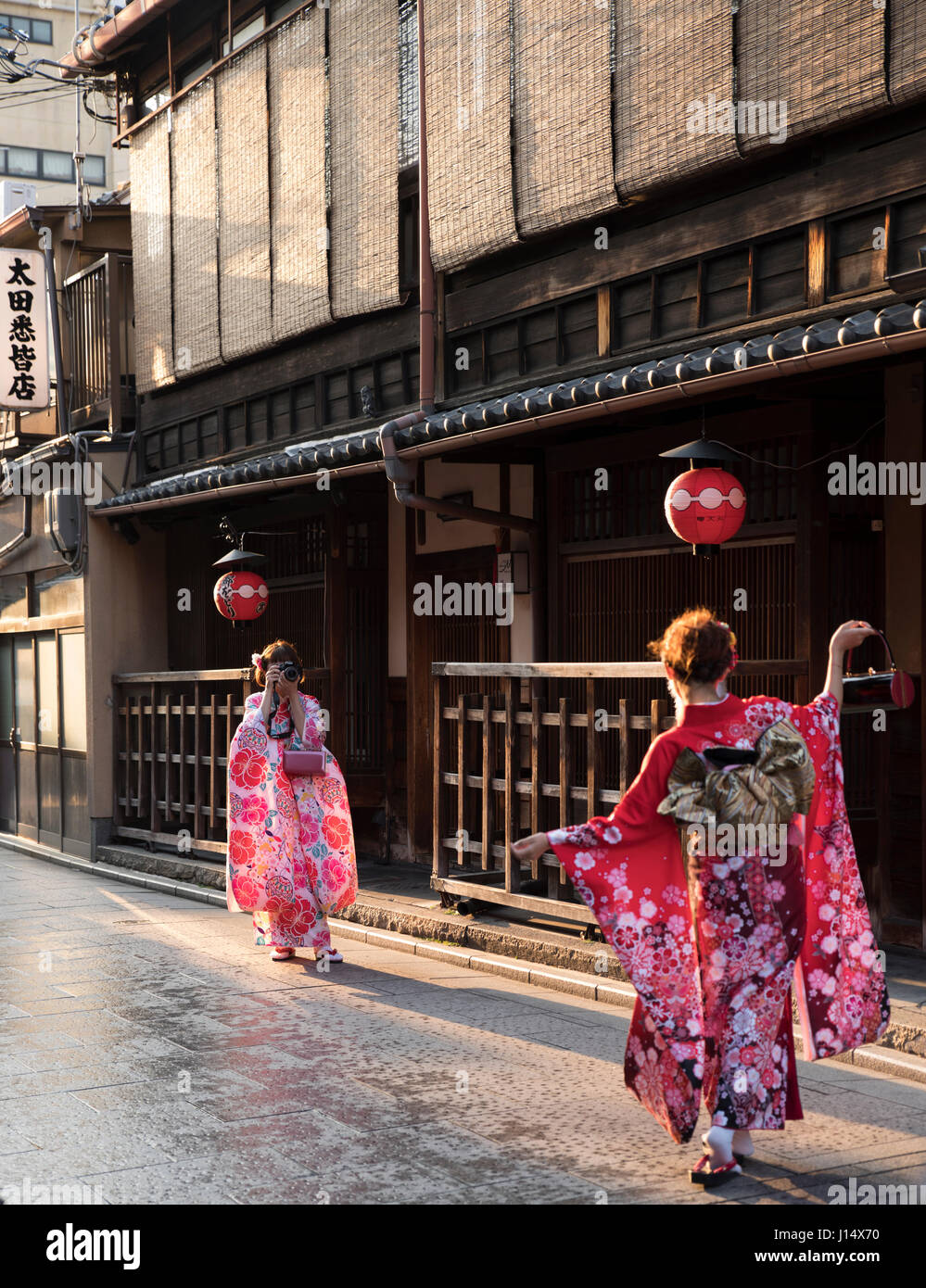 I turisti in kimono posa per foto in Hanami-koji Street, Gion, Higashiyama, Kyoto, Giappone Foto Stock