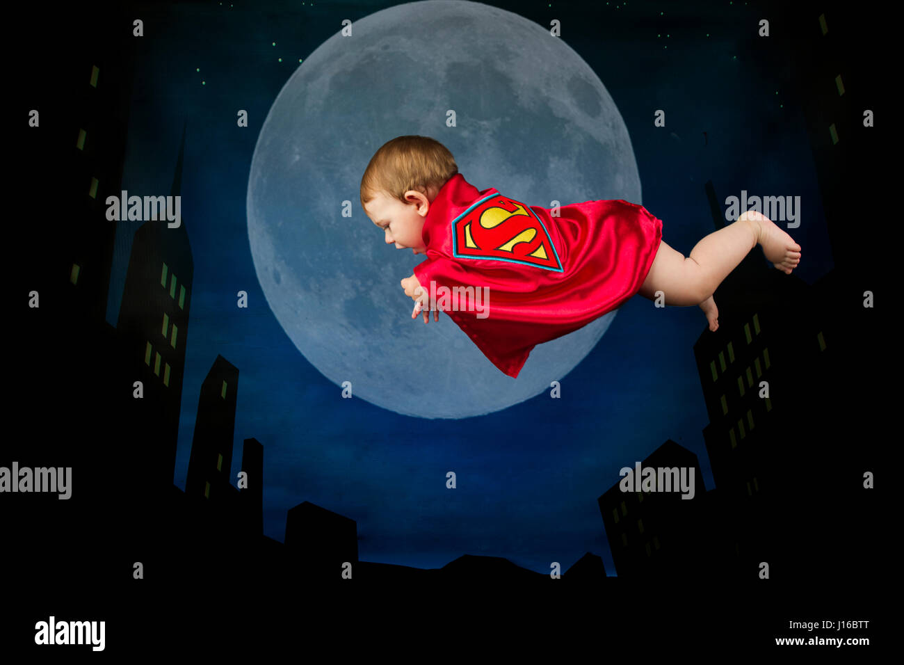 Stato di Washington, USA: Baby Superman " Mosche " attraverso il nightsky. Si tratta di un uccello? Si tratta di un piano? No, si tratta di una pinta di dimensioni di Superman. Da volare più veloce di un proiettile come Superman per web-imbracatura come il vostro quartiere amichevole Spiderman questi simpatici baby foto mostrano mini-supereroi in tutta la loro gloria. Completare con perfettamente creato mantelli, maschere e simboli di supereroi il cuore a colpi di fusione di Batman, Batgirl, Superman, Captain America e Wonder Woman in vetrina al classico da Supereroi DC e Marvel Comics nella piccola forma di neonati. Il supereroe-ventola e baby fotografo Christy Peter Foto Stock