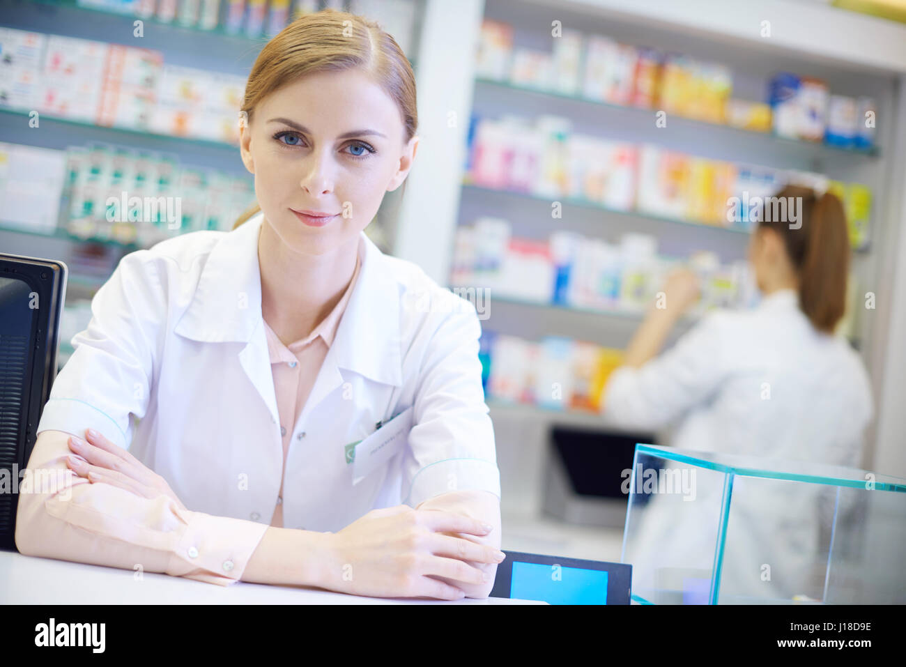 Giovane farmacista con le braccia incrociate Foto Stock