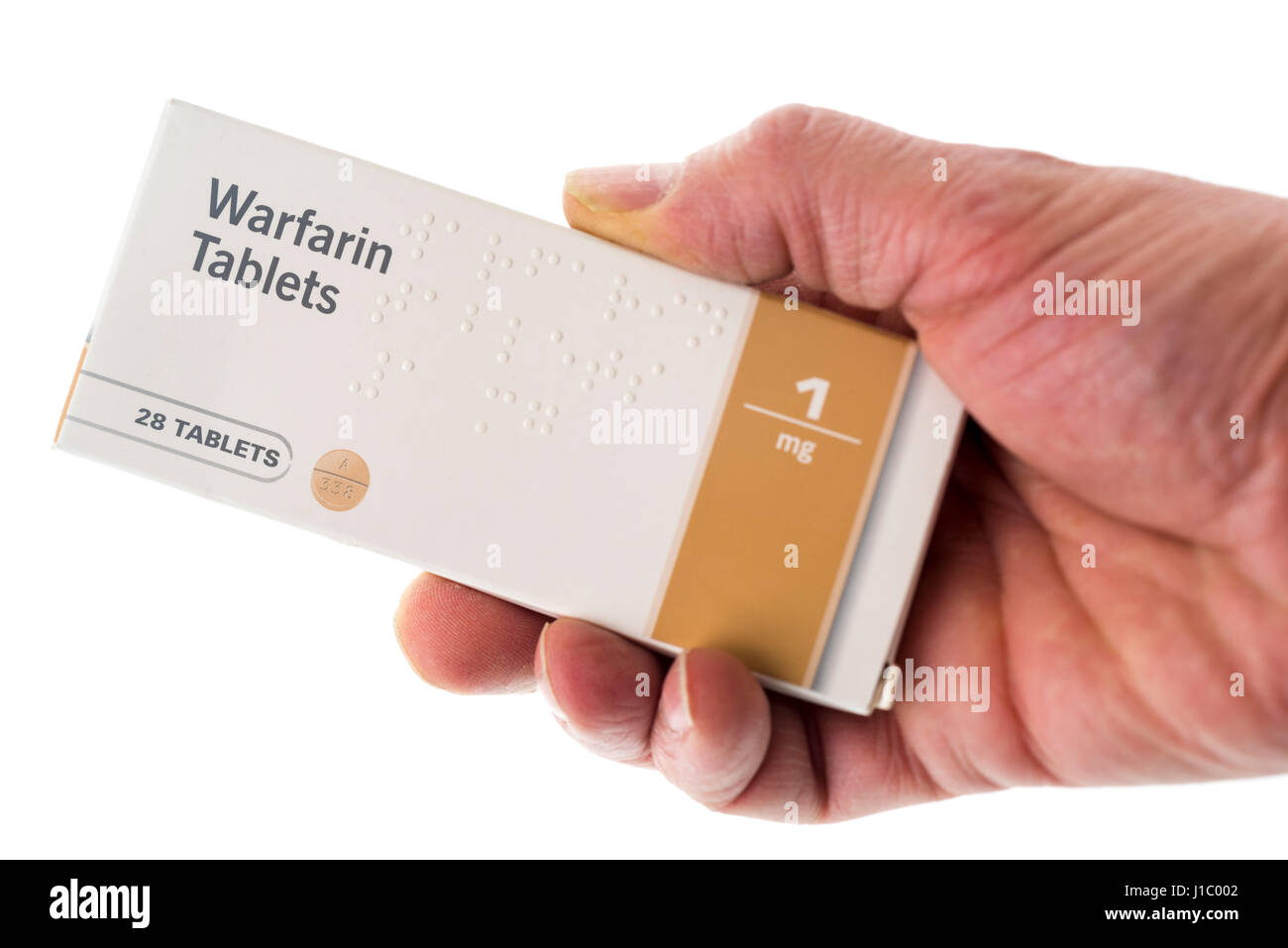 Maschio di mano che tiene il pacchetto di Warfarin compresse Foto Stock