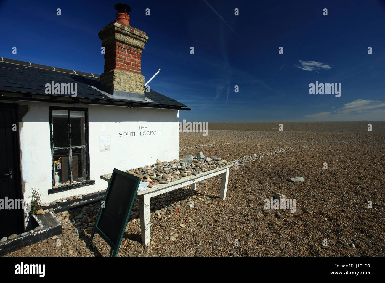 Sud belvedere sulla spiaggia di Aldeburgh Suffolk,sulla giornata di primavera nella luce del sole con cielo blu e ciottoli su un tavolo Foto Stock