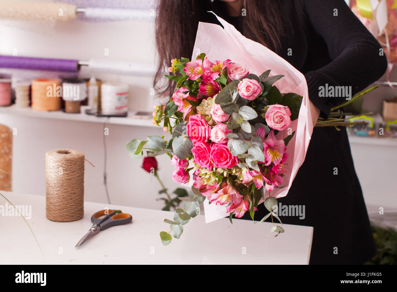 Fioraio rendendo il bouquet con rose Foto Stock