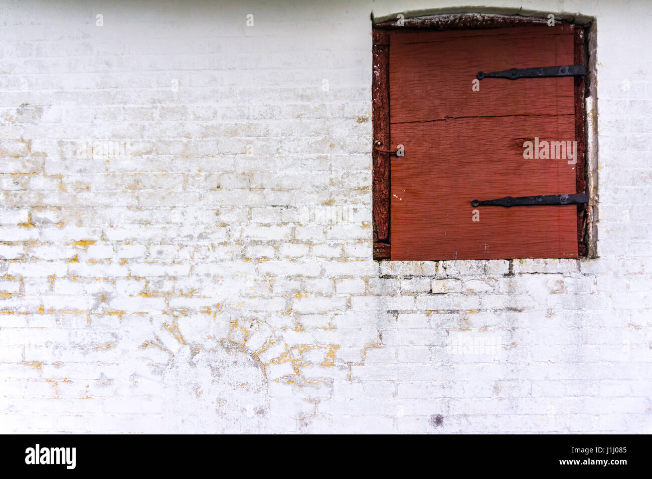 Una parete e un vecchio contrasty finestra di una fattoria danese Foto Stock