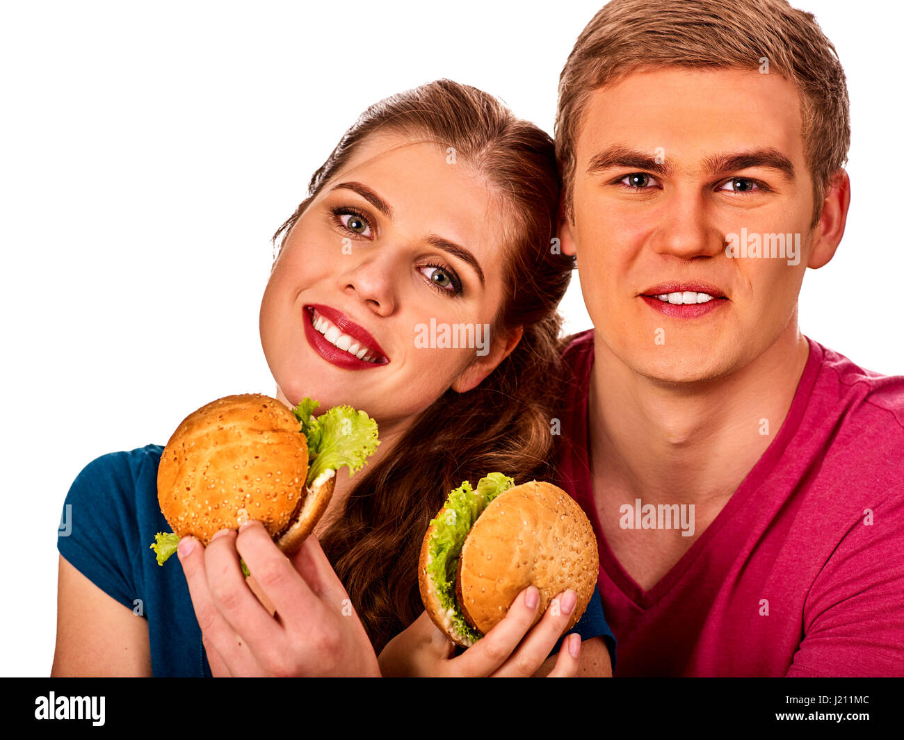 Paio di mangiare fast food. L uomo e la donna a mangiare hamburger Foto Stock