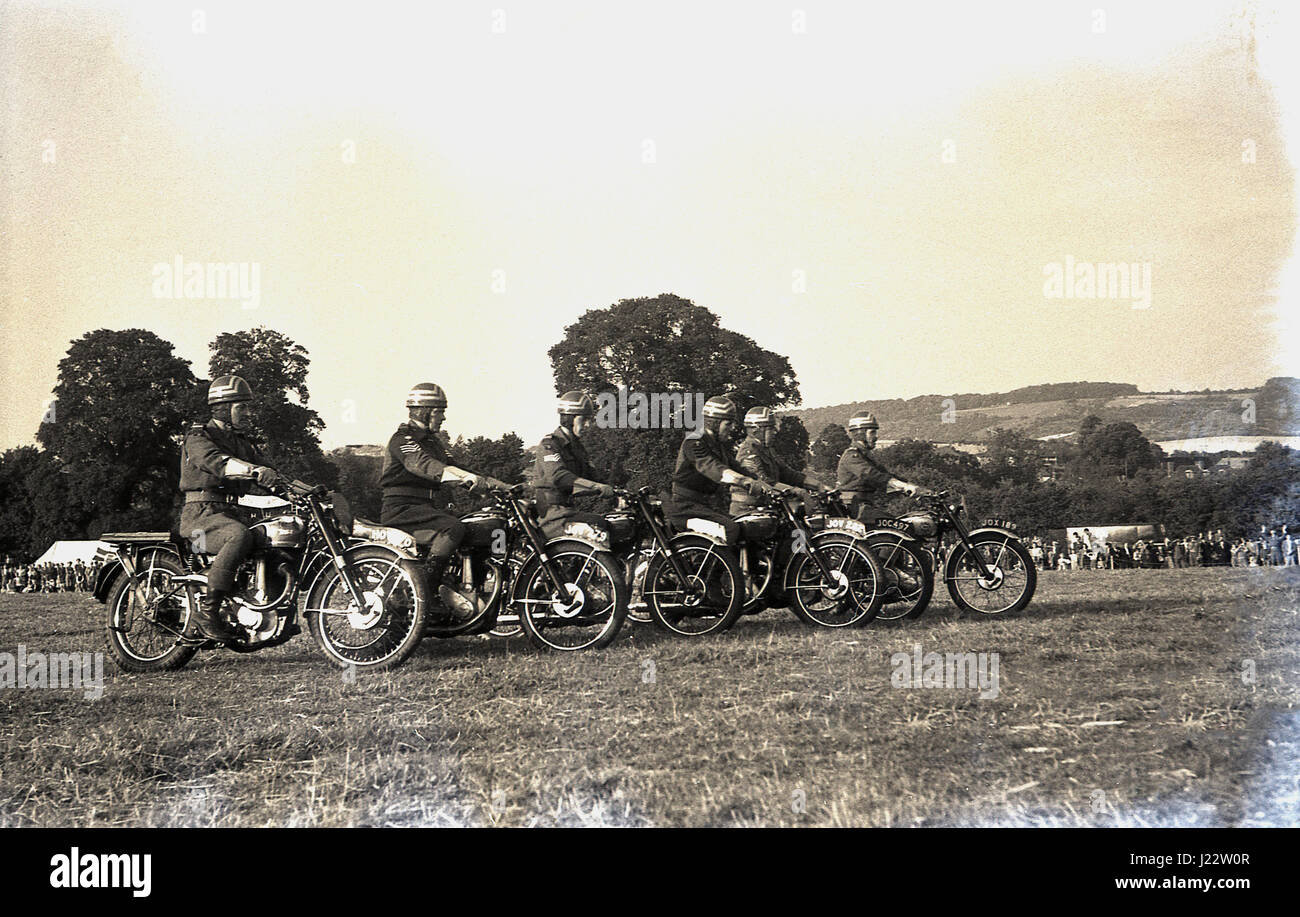 Degli anni Cinquanta, storico, un motociclo display o stunt team line up in un campo per eseguire presso la contea di Bucks mostrano, Inghilterra, Regno Unito. Foto Stock
