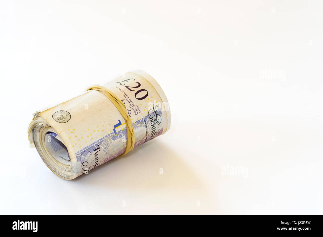 Rotolo o pacchetto di denaro.Stass di venti pound note. Foto Stock