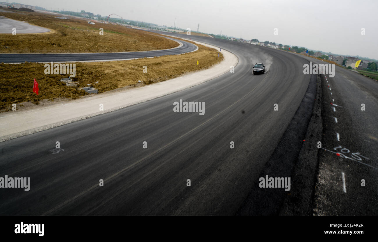 (170425) -- NANJING, 25 aprile 2017 (Xinhua) -- un auto corre su un test ad alta velocità via di Ford Proving Ground in Nanjing, a est della capitale cinese della provincia di Jiangsu, 25 aprile 2017. La pista di prova, che è 3,036.684 metri progettato con velocità massima a 160 chilometri all'ora, è interamente realizzato dalla società cinese e si prevede di mettere in esercizio nel mese di luglio. Della Cina di piste di prova di terreno di prova una volta erano tutti costruiti da imprese di costruzione straniere. (Xinhua/Li Xiang) (lfj) Foto Stock