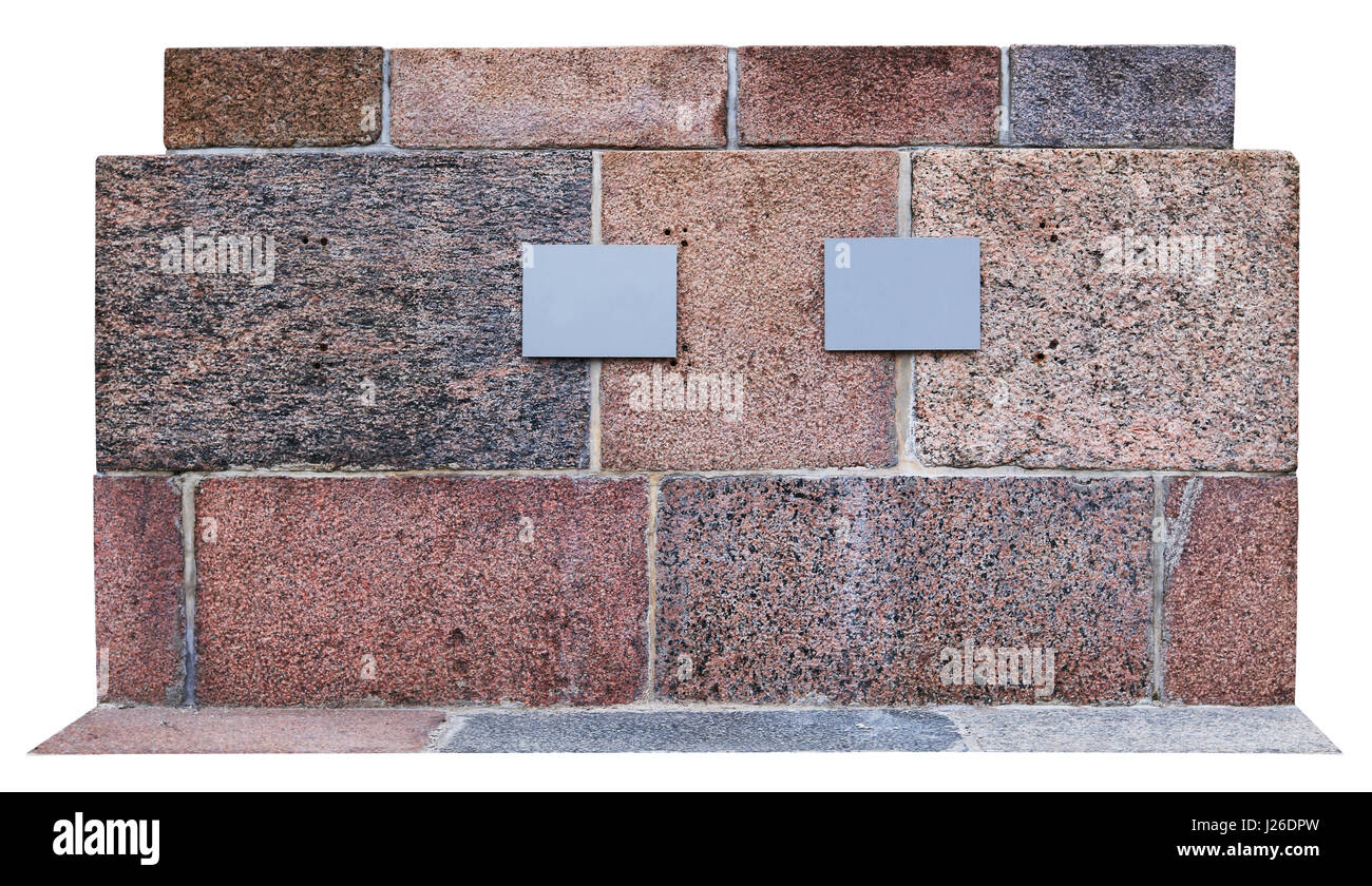 La base di un monumento storico è costituito da blocchi di granito. Ci sono due piastre metalliche con informazioni. isolato su bianco Foto Stock