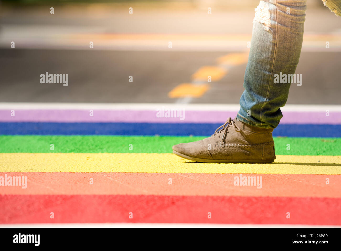 Sezione bassa della persona che cammina su orgoglio LGBT colorato in ambiente urbano Foto Stock