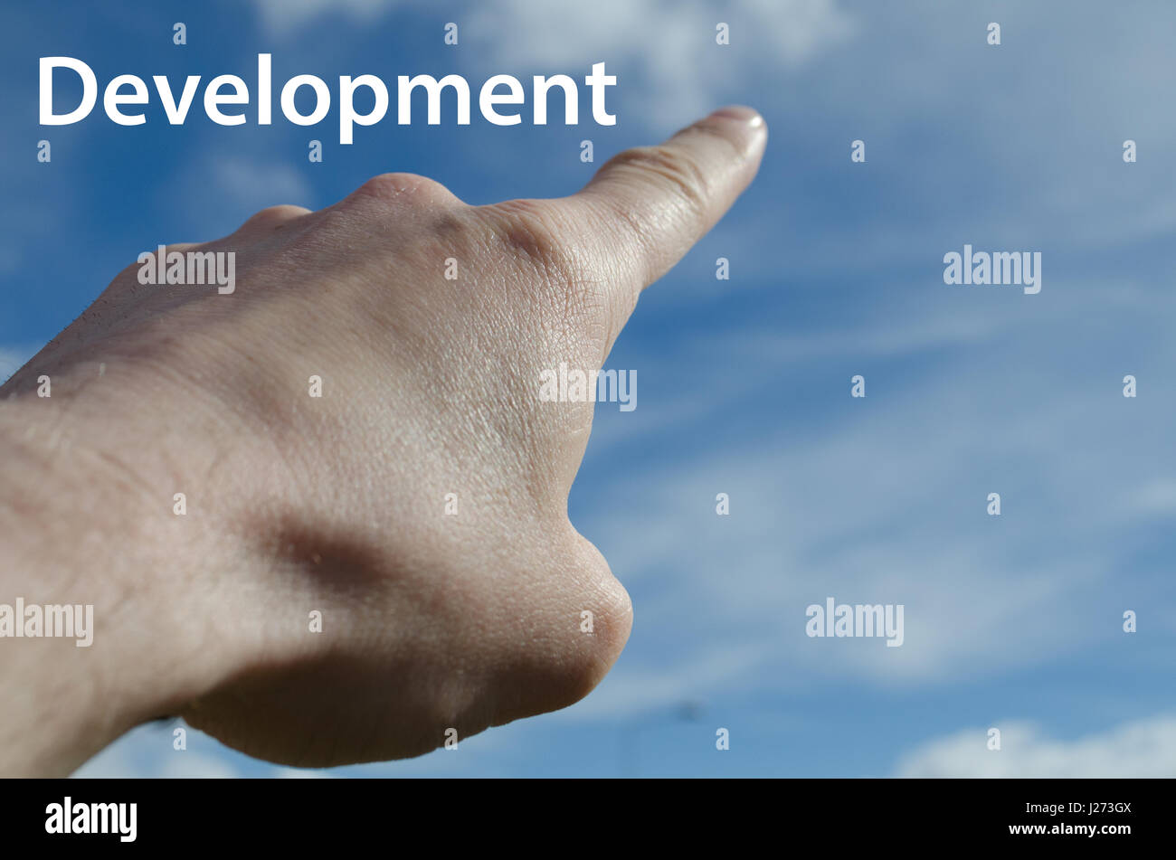 Mano con il dito puntato verso il cielo blu development concept Foto Stock