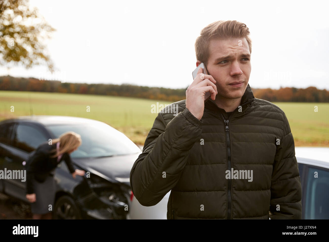 L'uomo chiamando per relazione incidente di auto sulla strada di campagna Foto Stock