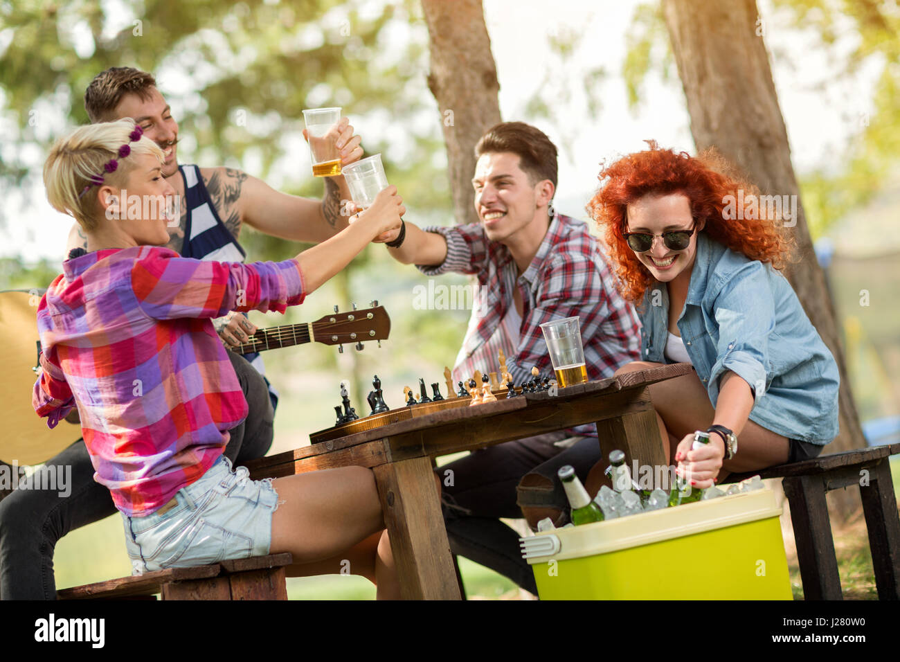 Società Allegro toast con bicchieri di birra fredda in foresta Foto Stock