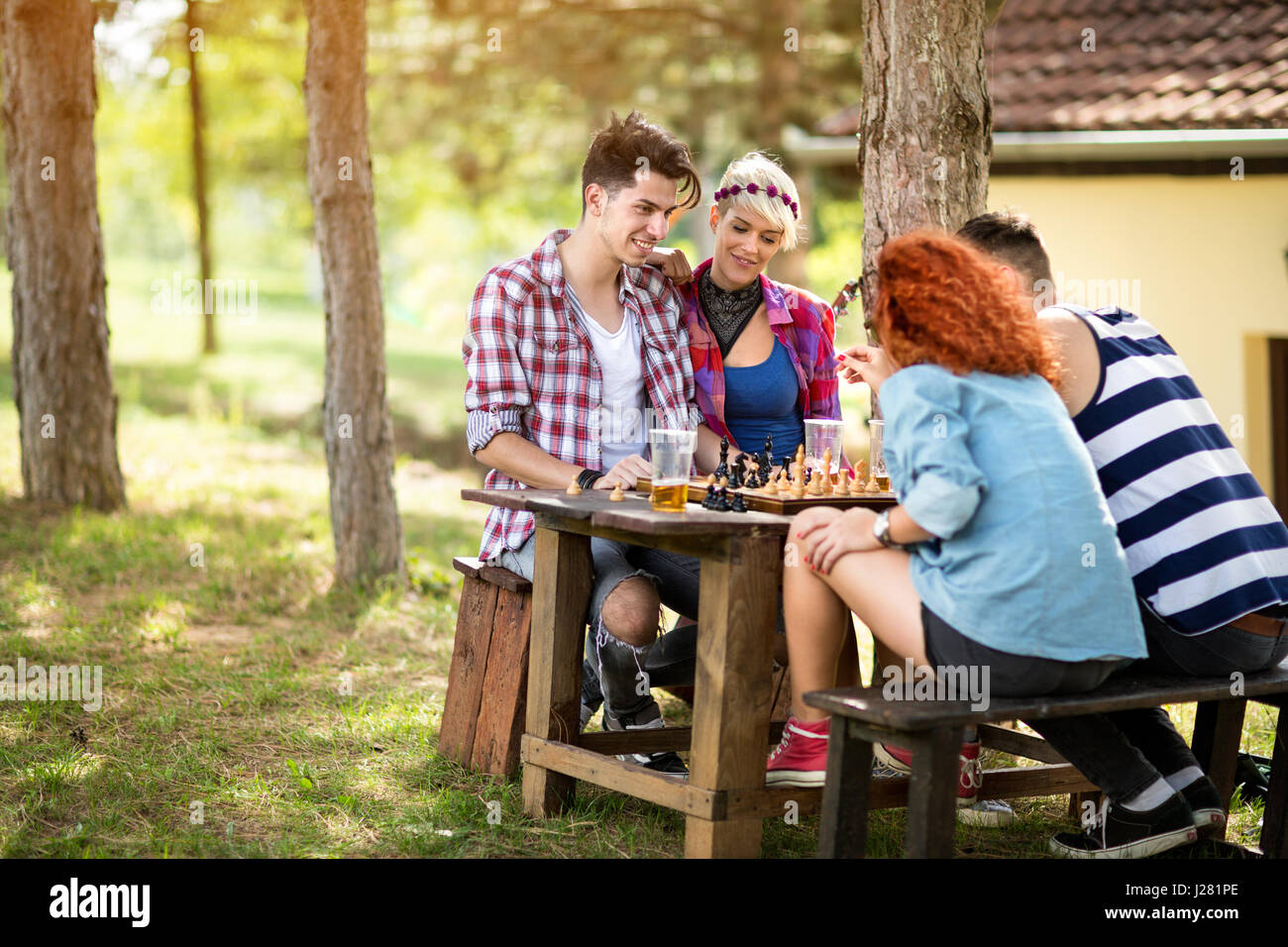 Team di giovani con piacere giocare a scacchi su picnic Foto Stock
