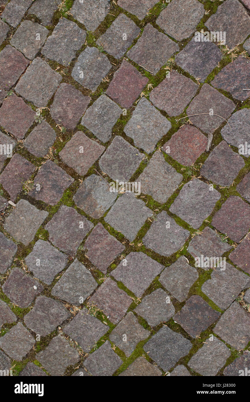 Vecchio stile di mattoni o pavimentazione in pietra per un marciapiede o strada. Foto Stock