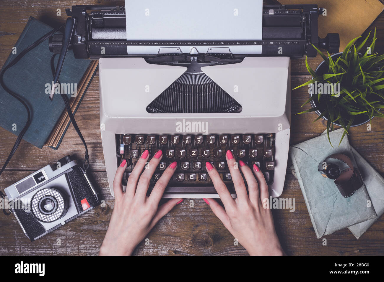 Mani femminili la scrittura su una vecchia macchina da scrivere Foto Stock