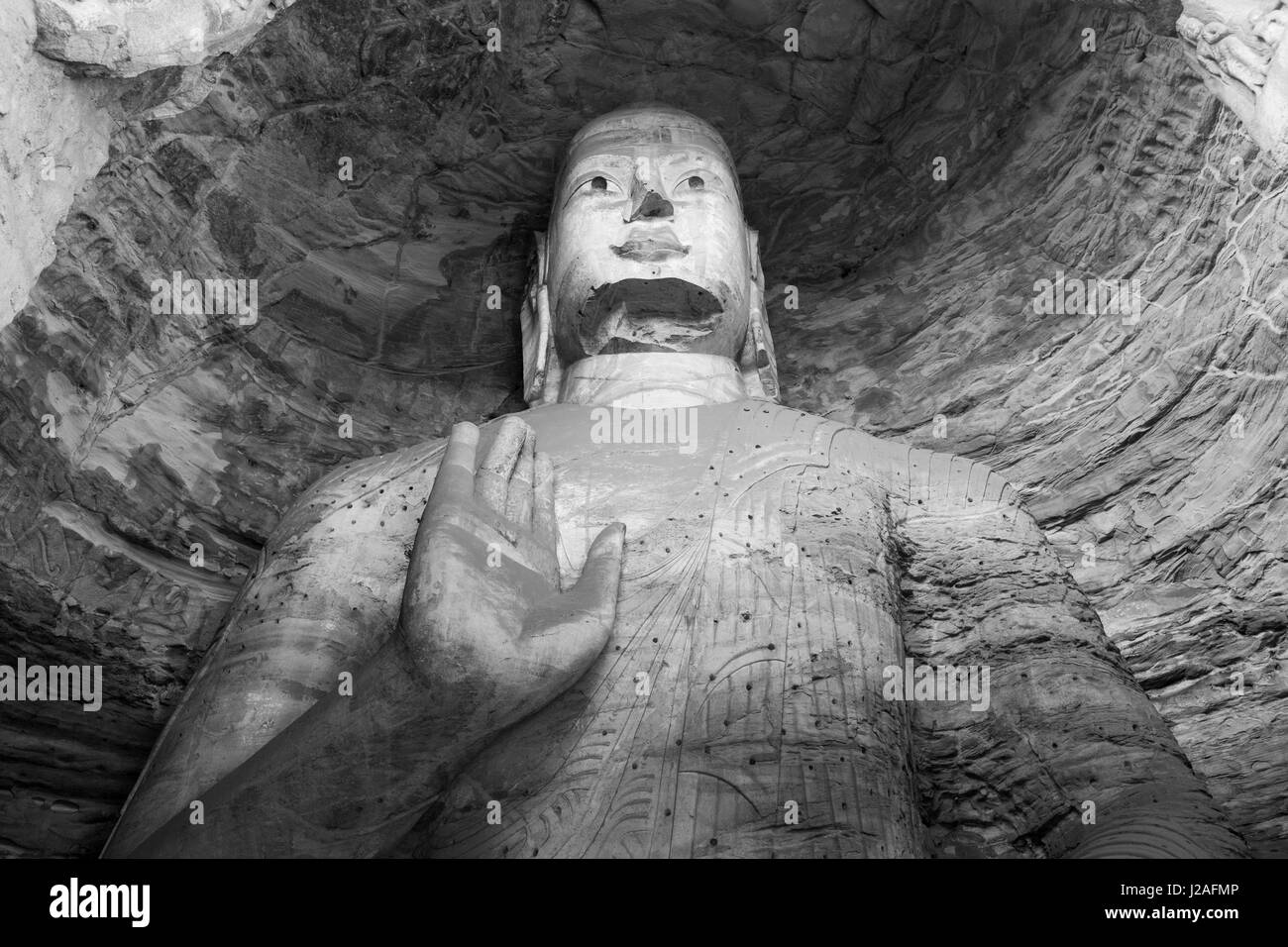 La Cina, nella provincia di Shanxi, Datong, antiche sculture buddista all'interno di cave 18 all'interno di Yungang Grotte del Buddha Foto Stock