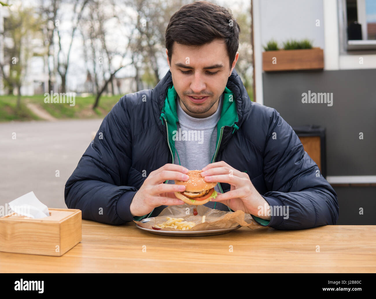 Un Ritratto di giovane uomo in cibo di strada cafe Foto Stock