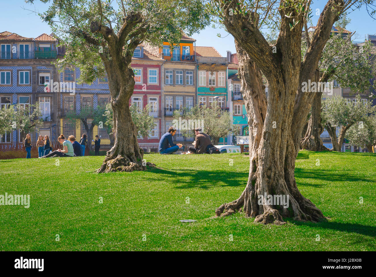 I giovani parcheggiano l'Europa, con la vista dei giovani che si rilassano nel pomeriggio estivo in un parco nella città portoghese di Porto. Foto Stock
