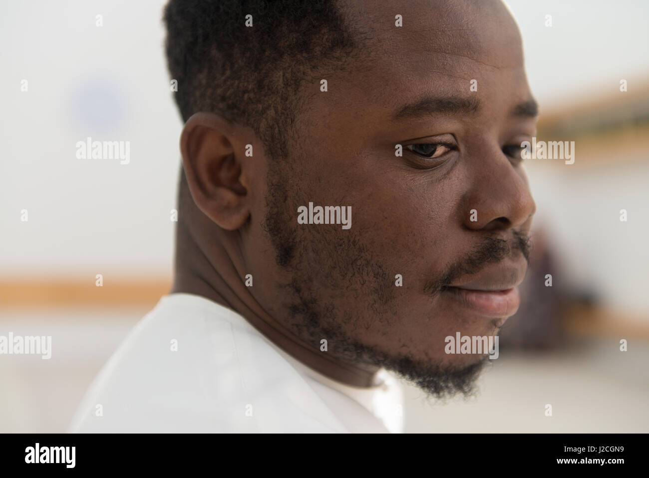 Musulmani africani uomo rendendo tradizionale preghiera a Dio indossando un cappello tradizionale Dishdasha Foto Stock
