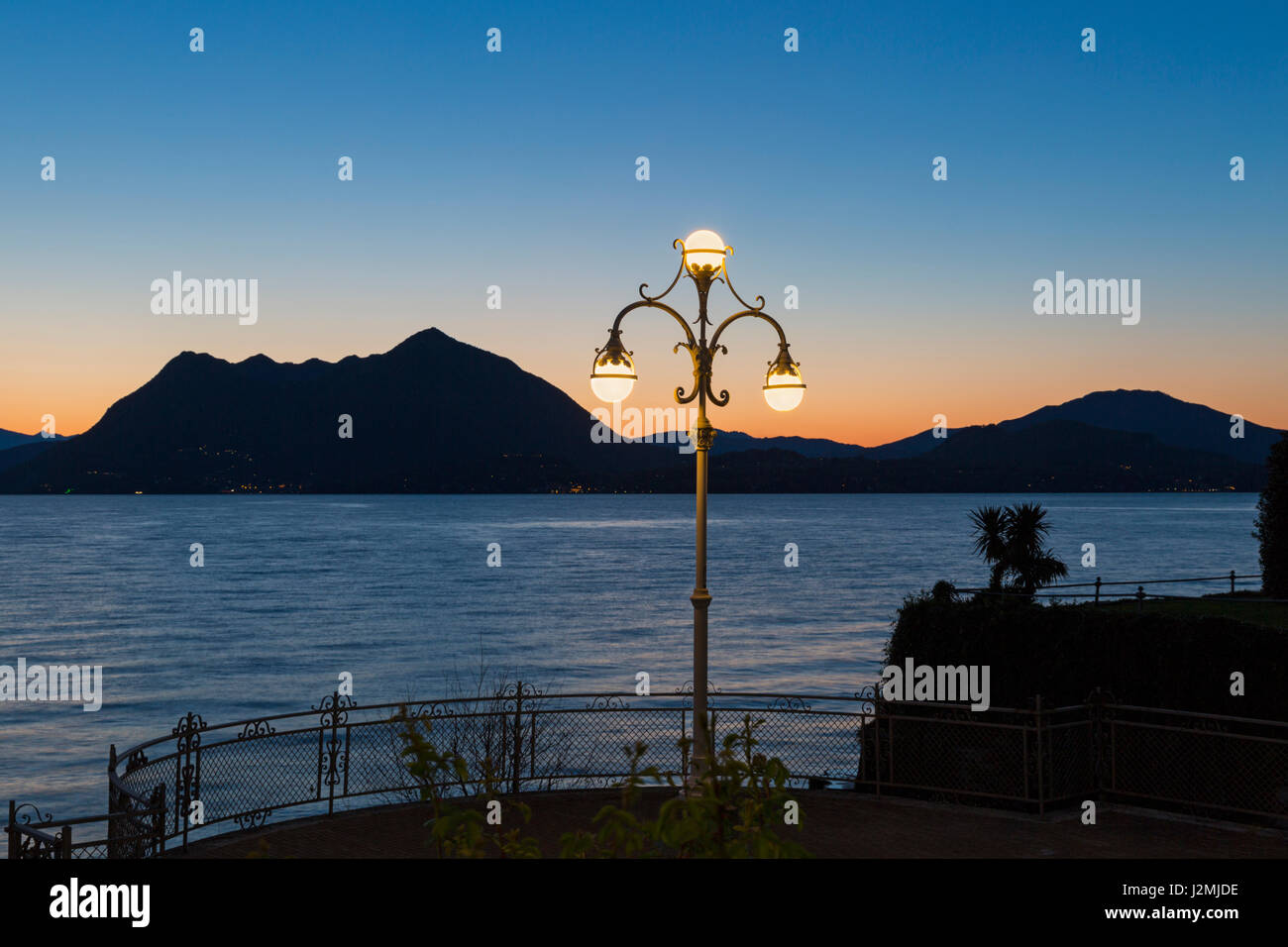 Lampione ornati sul lungolago con stupende vedute all'alba a Stresa Lago Maggiore in Italia nel mese di aprile Foto Stock