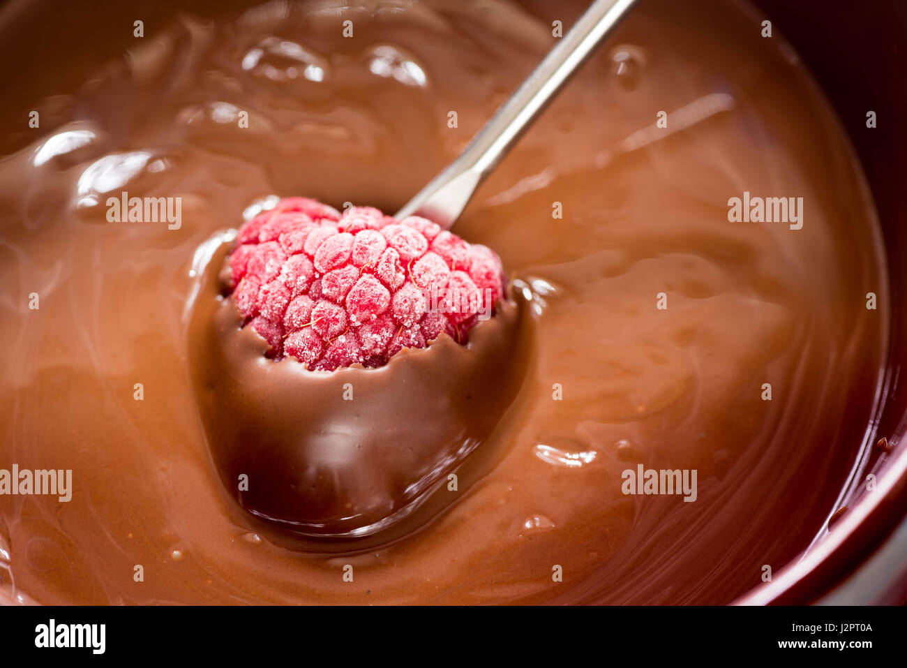 Primo piano di lampone e la fonduta di cioccolato Foto Stock