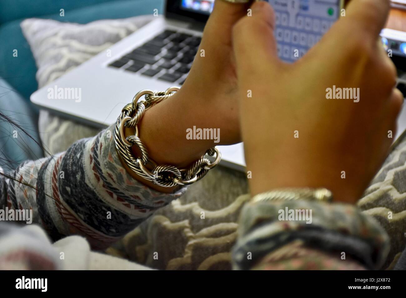 Donna con David Yurman designer gioielli scrivere messaggi su un iPhone Foto Stock