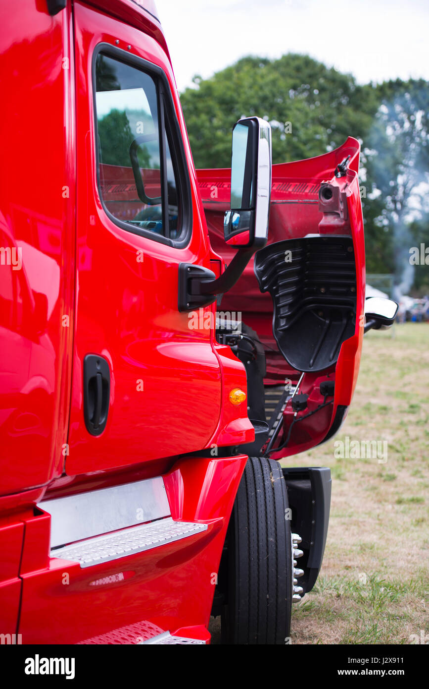 Grande e moderno di colore rosso brillante carrello semi professionale per il traffico commerciale con un cofano aperto nel parcheggio per verificare la condizione tecnica dell'en Foto Stock