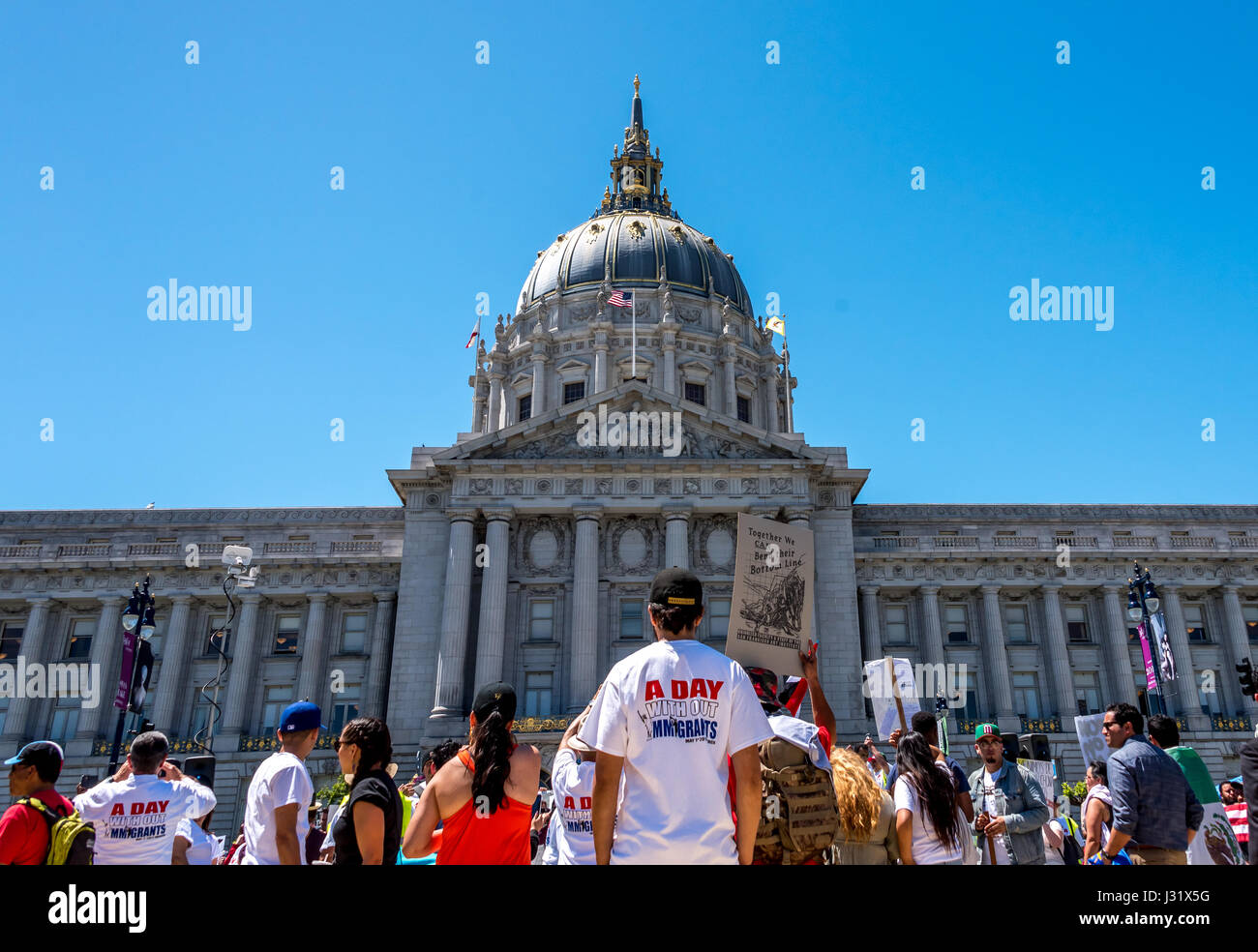 San Francisco, California, Stati Uniti d'America. Il 1 maggio, 2017. Un uomo che indossa il 'Un Giorno senza immigrati' maglietta commemorativa prima di San Francisco City Hall come il 1 maggio 2017, Giorno senza immigrati marzo termina al Civic Center Plaza. Più di 40 città in U.S.A. inscenato manifestazioni di protesta per il 'Day senza un immigrato.' a San Francisco da soli, migliaia sono scesi in piazza per protestare Trump's le politiche di immigrazione e di mostrare il proprio sostegno per i diritti degli immigrati. Credito: Shelly Rivoli/Alamy Live News Foto Stock