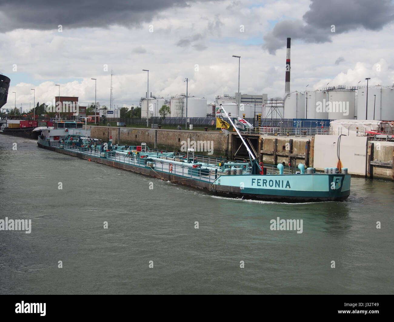 La Feronia, una nave costruita nel 1972, è fotografata al Boudewijnsluis nel porto di Anversa. E' un esempio di tecnologia marittima e di operazioni portuali industriali della metà del XX secolo. Foto Stock