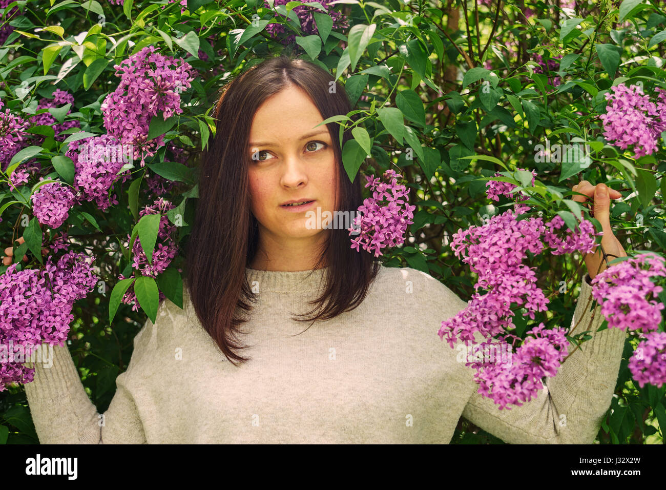 Un ritratto femminile con molla fioritura lilla Foto Stock